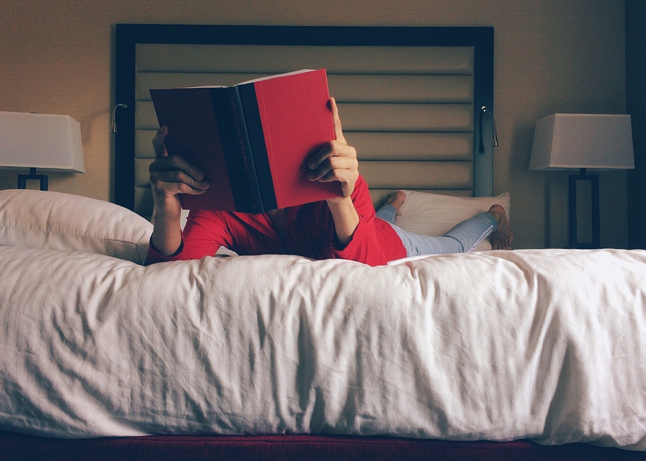 person reading on bed at night